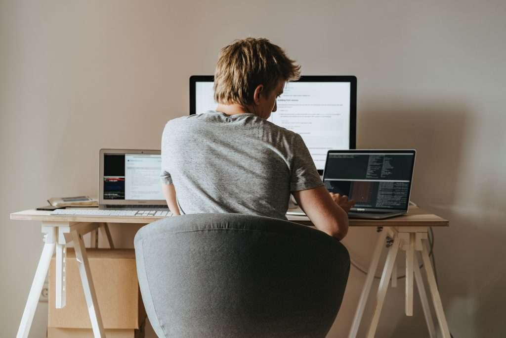 man sitting at desk writing