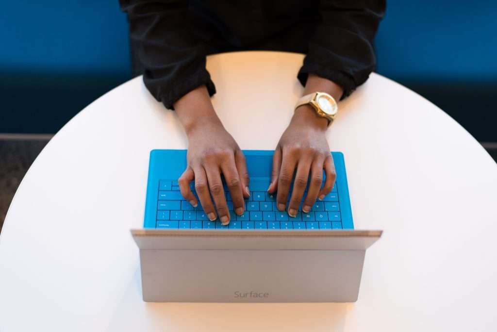 person typing on tablet