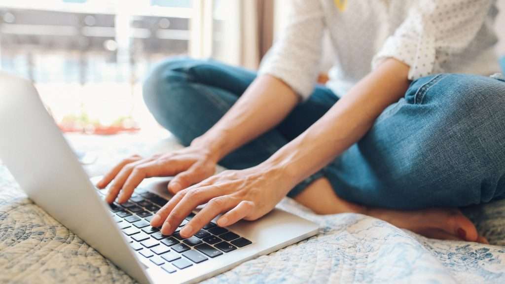 writing on laptop