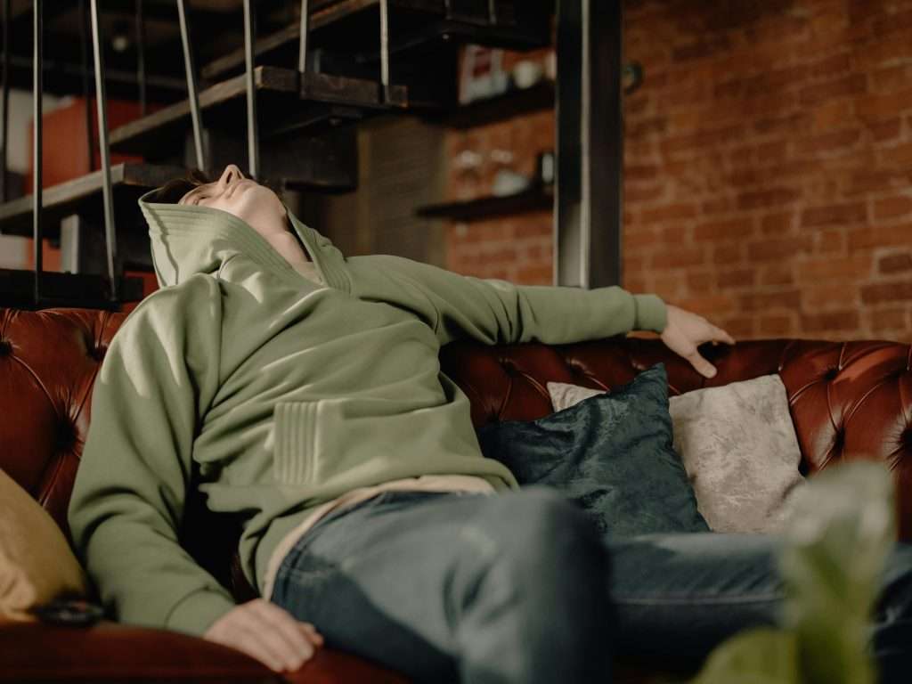 teenager sitting bored on sofa